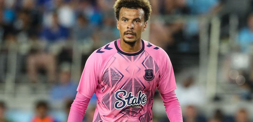 Goalkeeper wearing pink jersey during match action