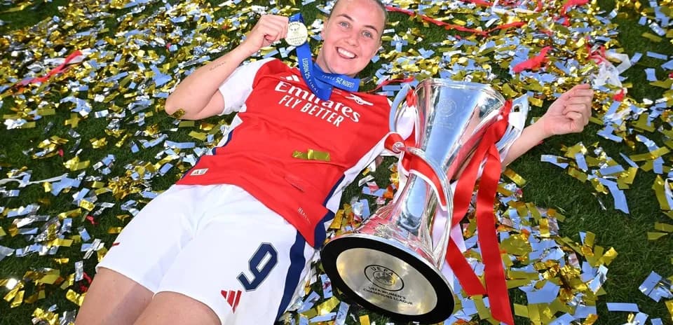 Player celebrating with trophy and medal on confetti