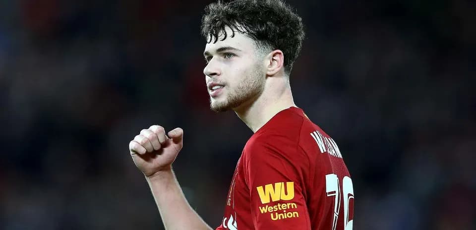 Player celebrating in Liverpool home jersey during match