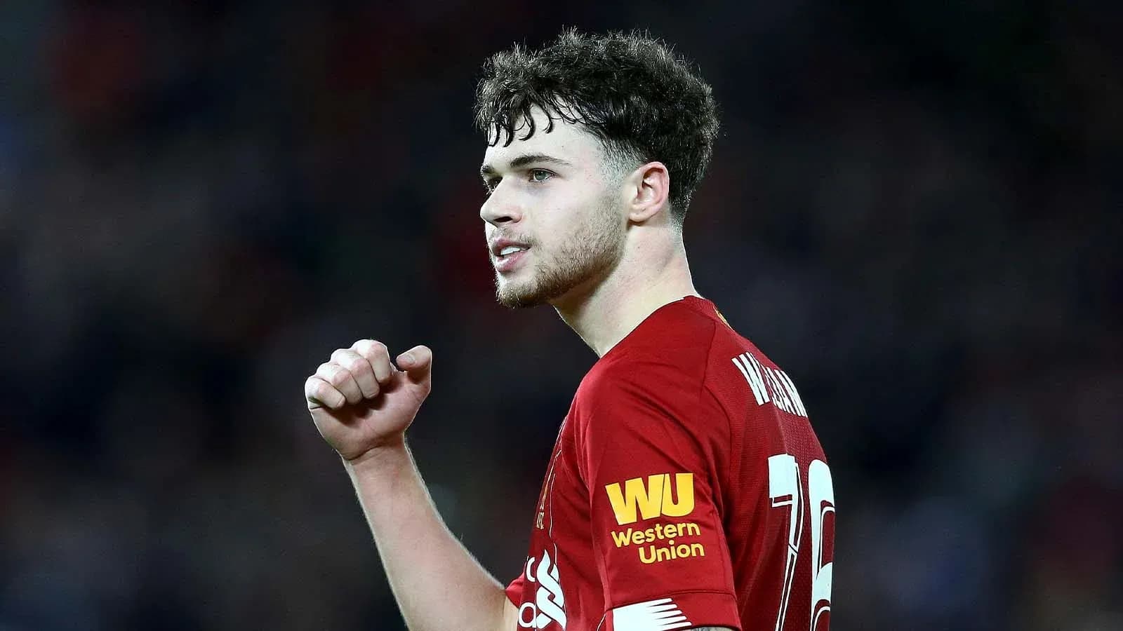 Player celebrating in Liverpool home jersey during match