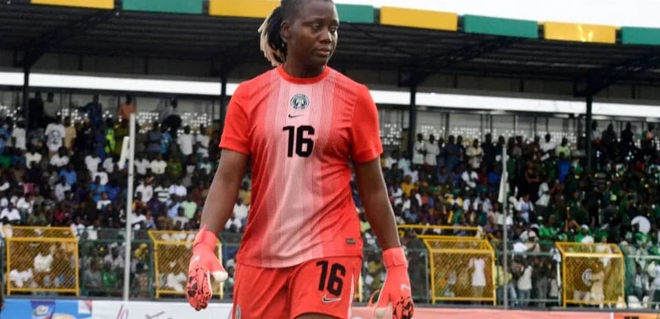 Goalkeeper in red uniform walking off the field