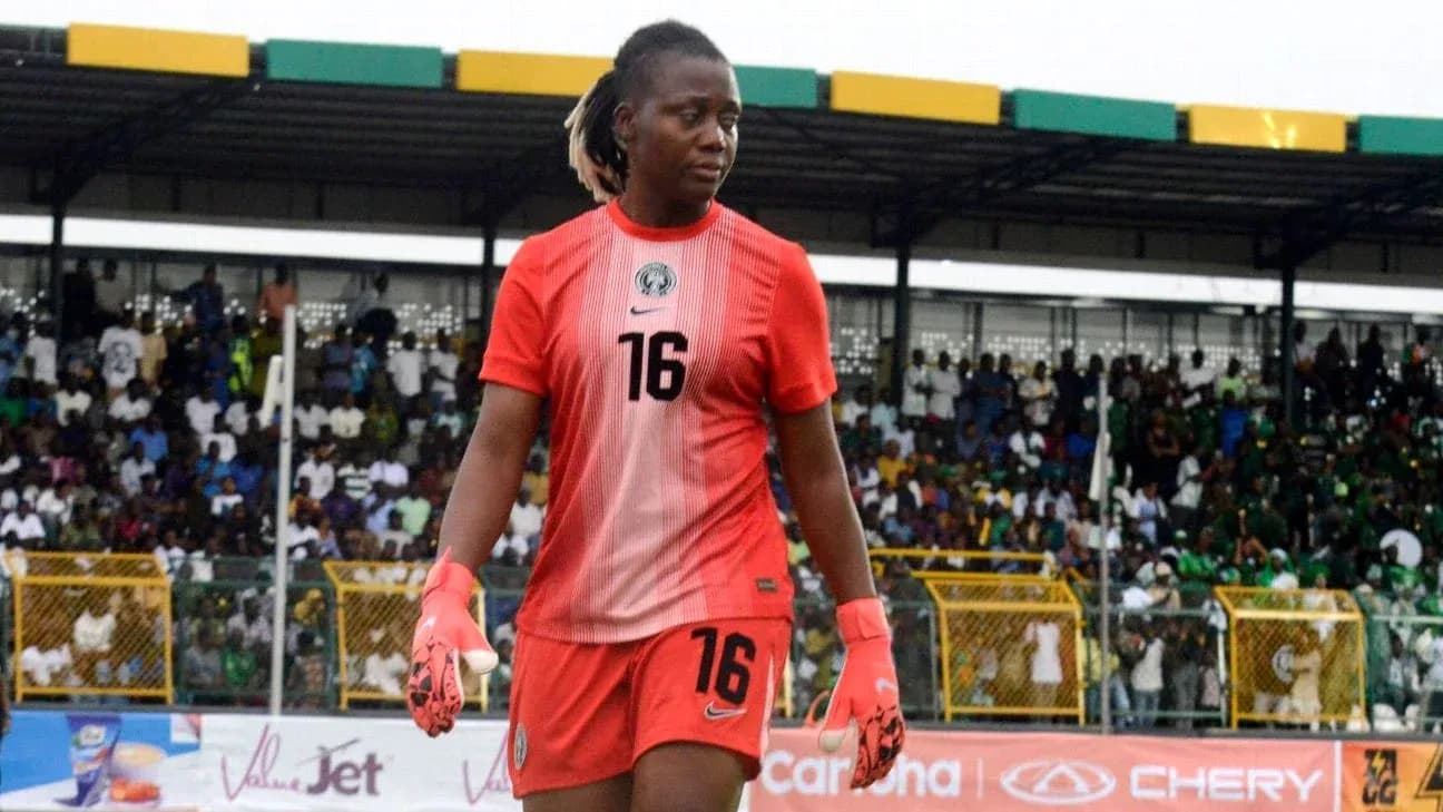 Goalkeeper in red uniform walking off the field