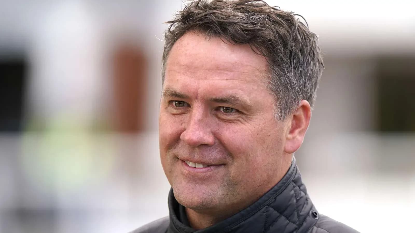Man smiling during a sports interview outdoors