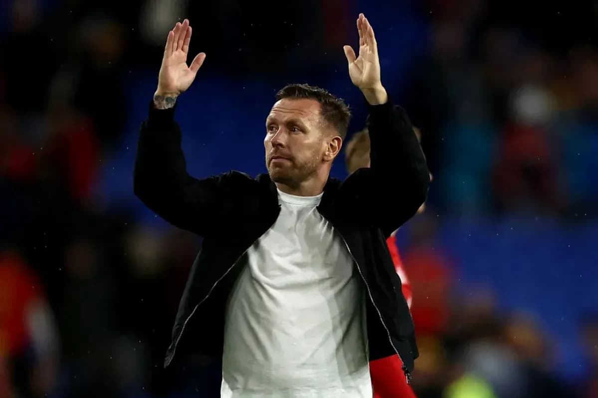 Person waving to crowd after match conclusion