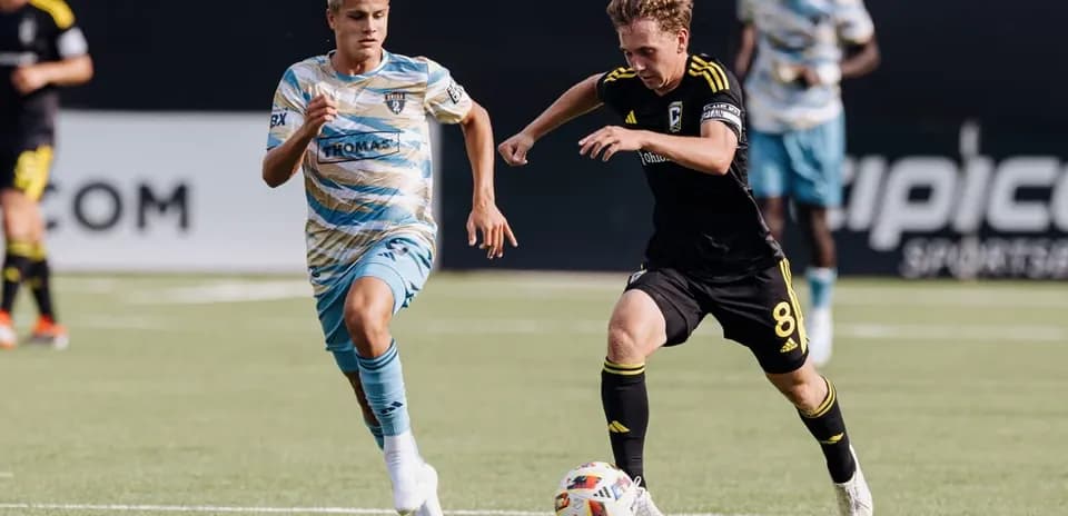 Two players competing for the ball in football match