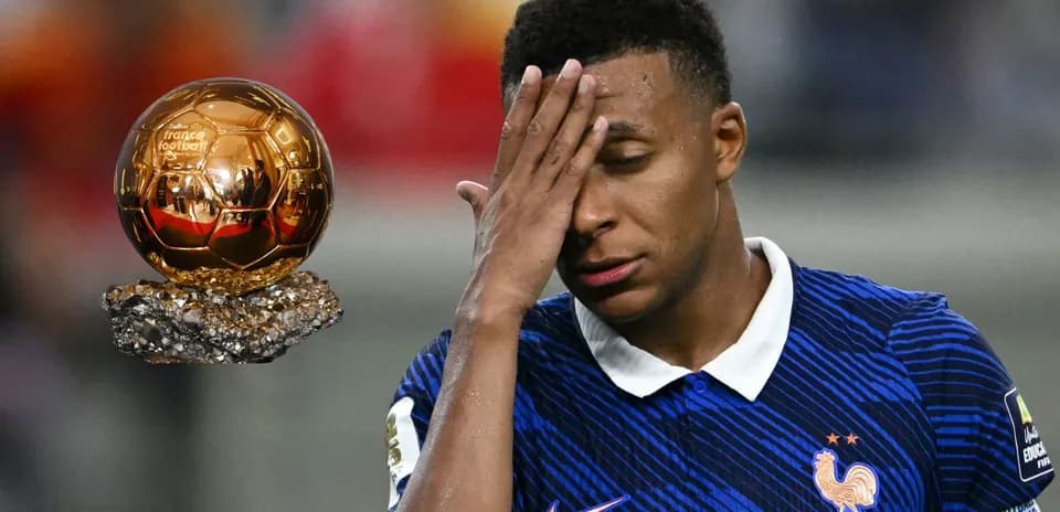Player in France kit reacting near Ballon d'Or trophy