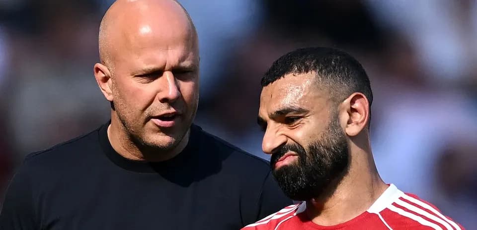 Two men talking on the sidelines of a match