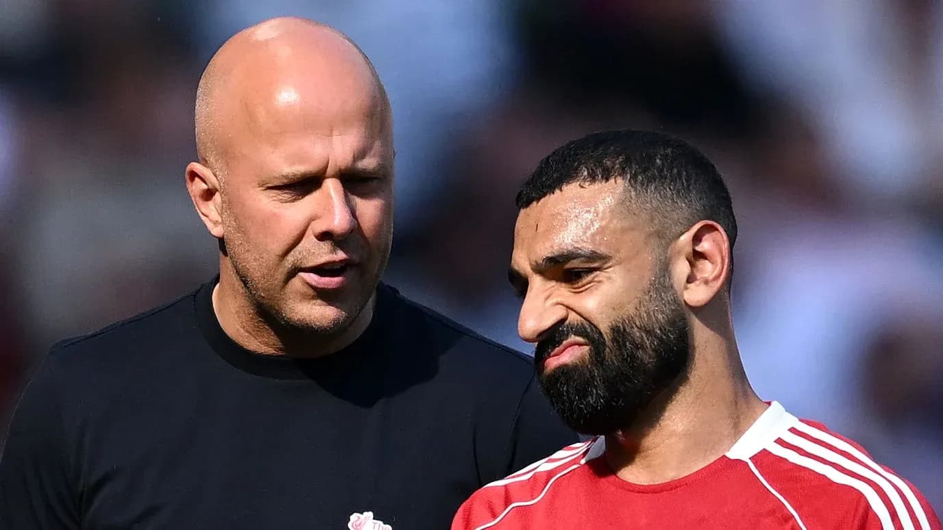 Two men talking on the sidelines of a match