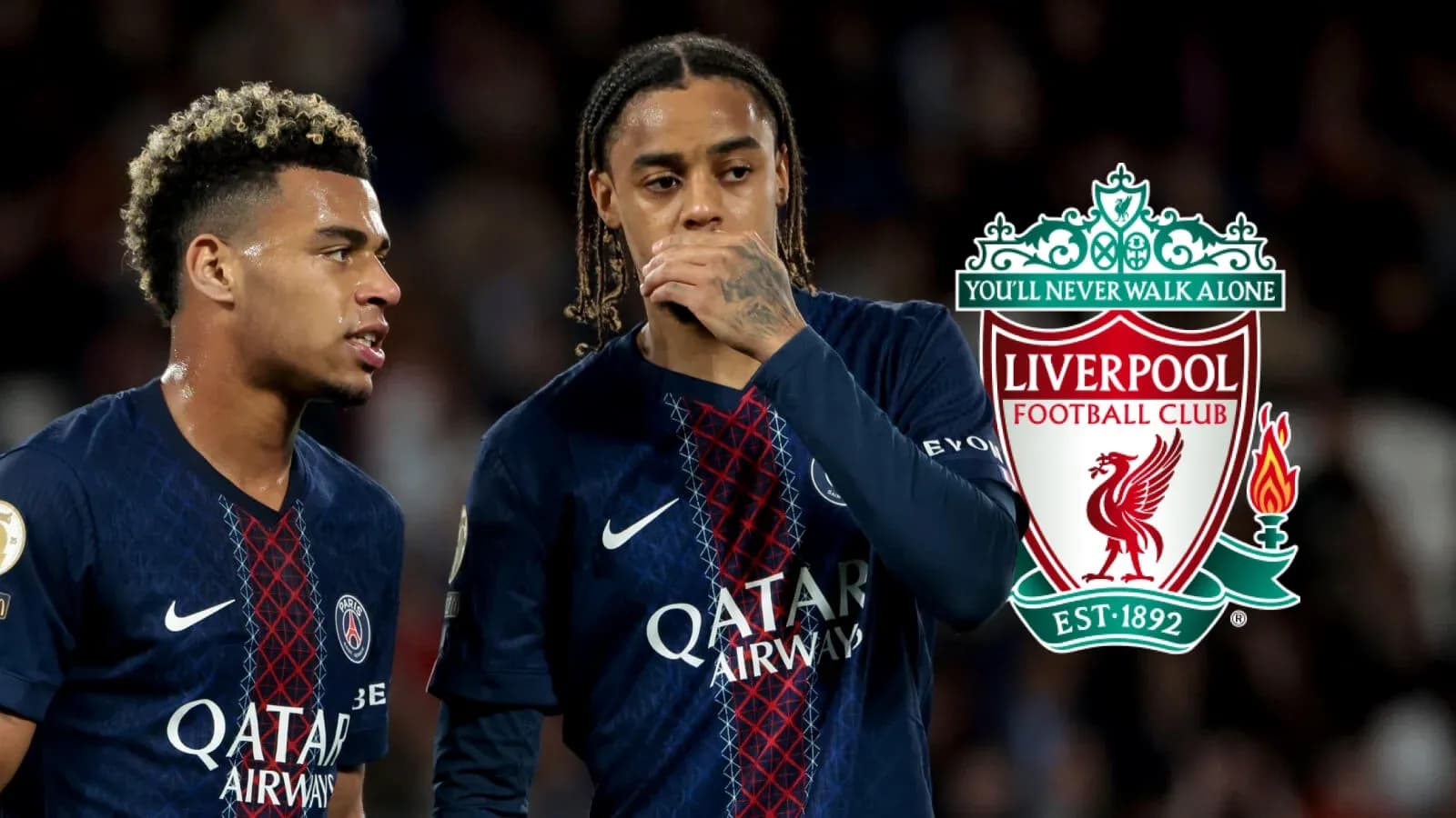 Two players discussing during match with Liverpool logo