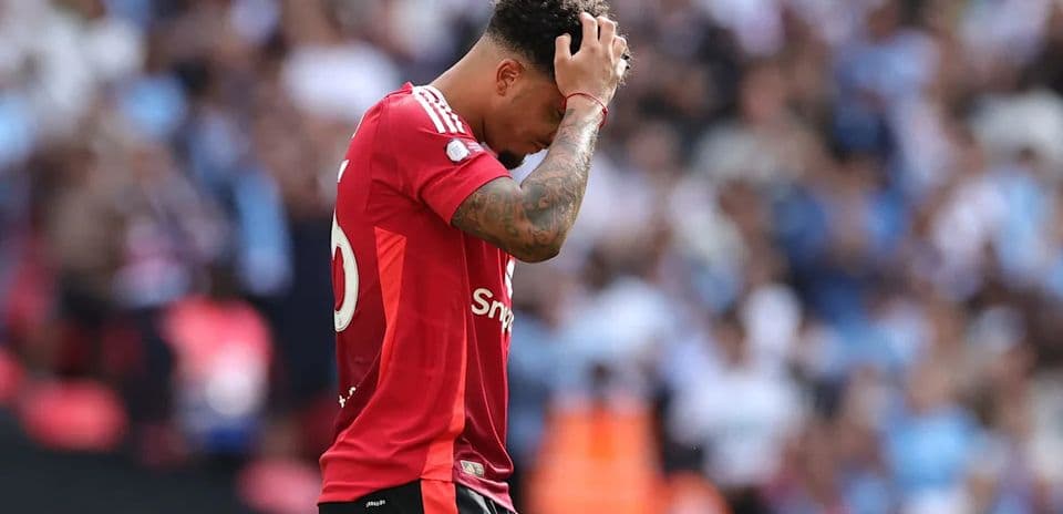 Player holding head during match in stadium