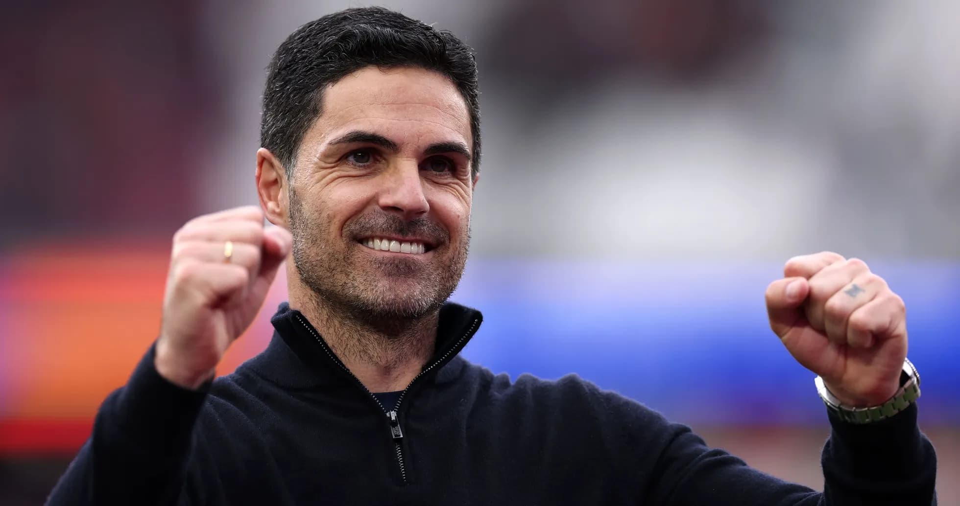Manager celebrating with raised fists and smile