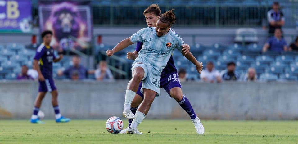 Players competing for the ball during Orlando City II match