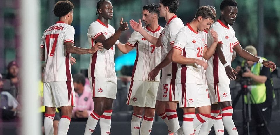 Canada players celebrating after scoring a goal