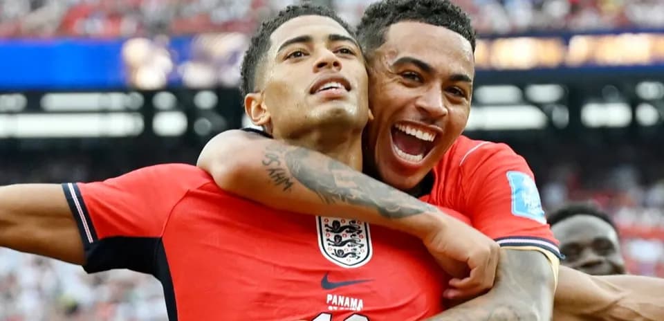Two England players celebrating a goal together
