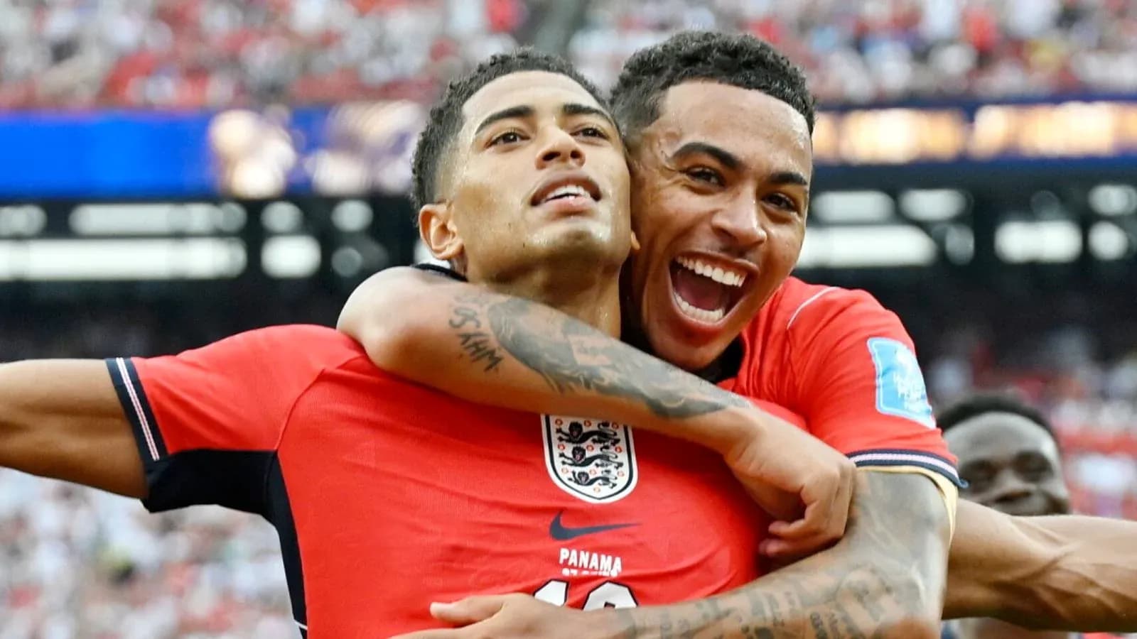 Two England players celebrating a goal together