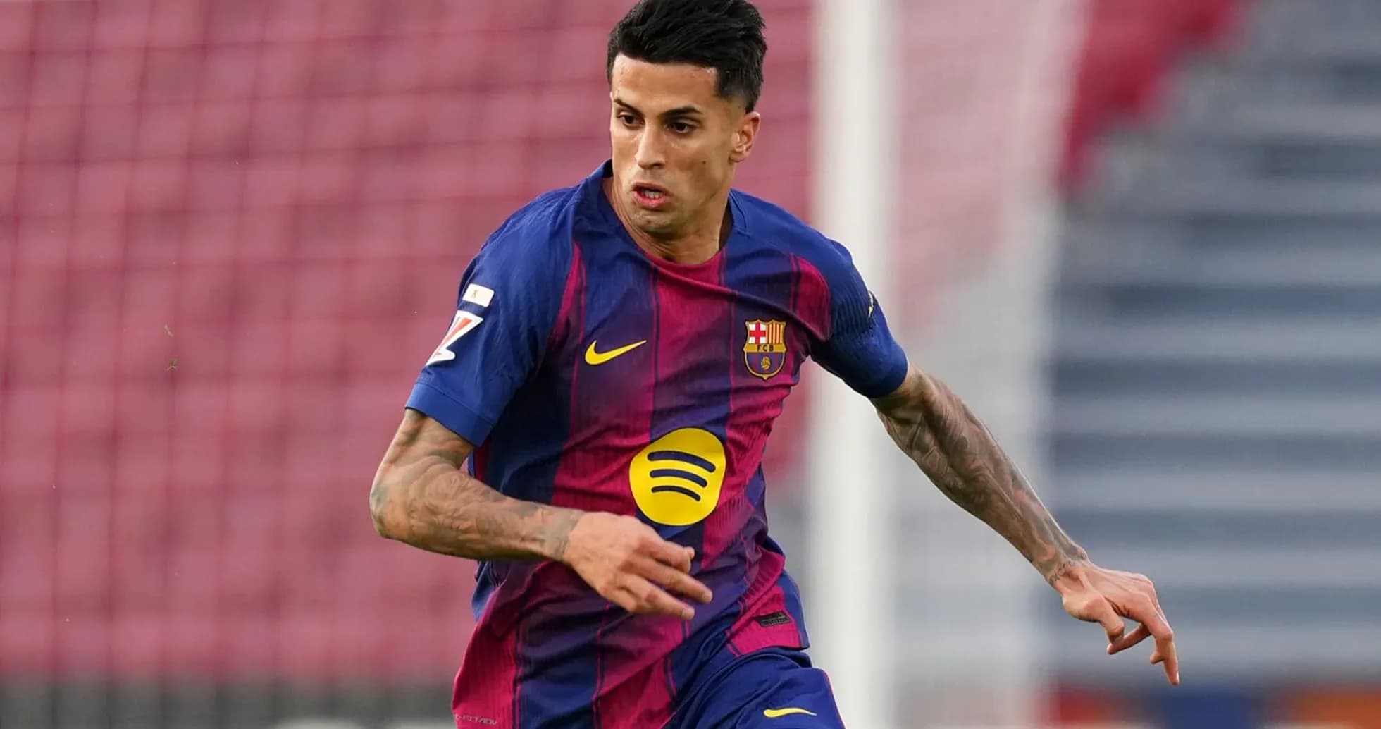 Player in FC Barcelona kit running on the field