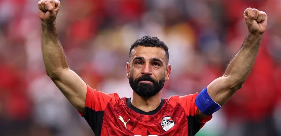 Player celebrating with raised fists in red jersey