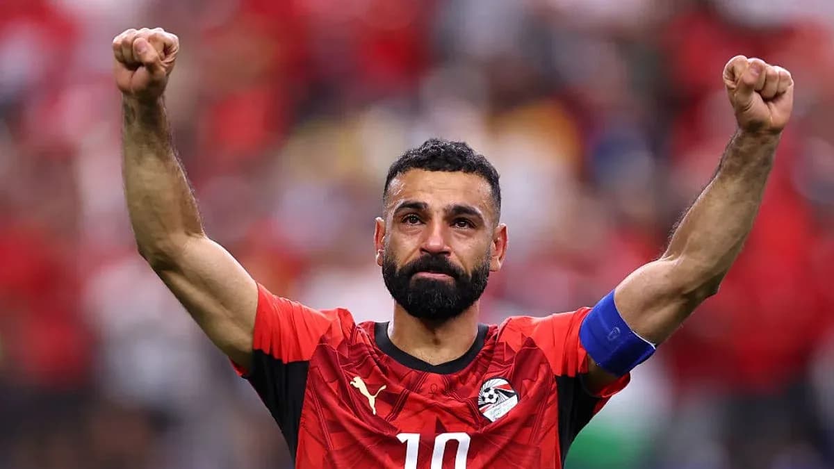 Player celebrating with raised fists in red jersey