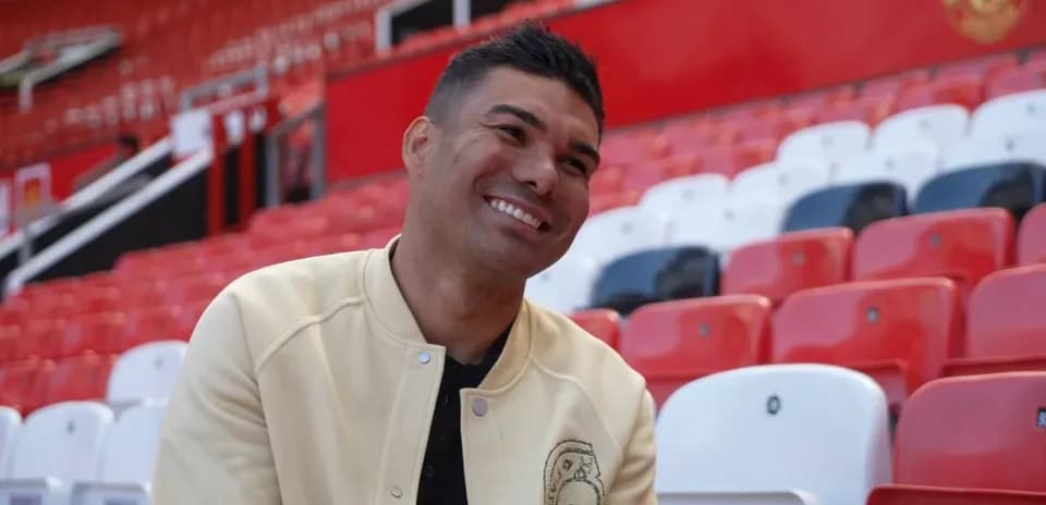 Player sitting in empty stadium seats at Old Trafford