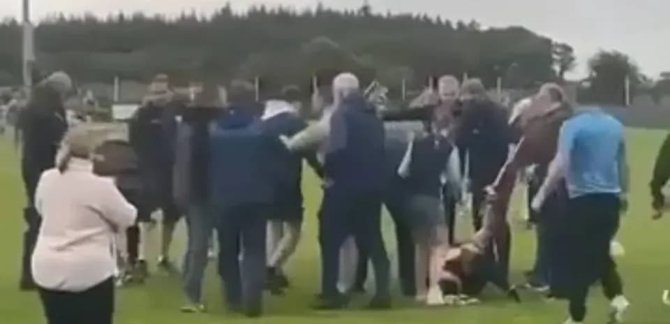 Crowd gathered around a player on the field