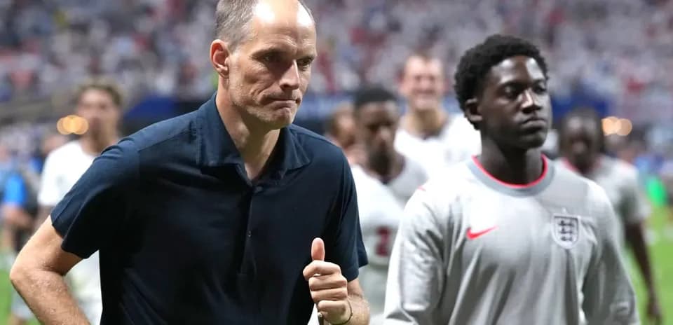 Coach and players walking off the field after match