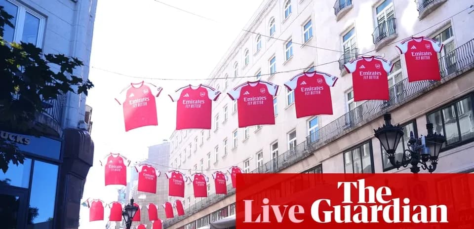 Arsenal jerseys hanging between buildings in city street