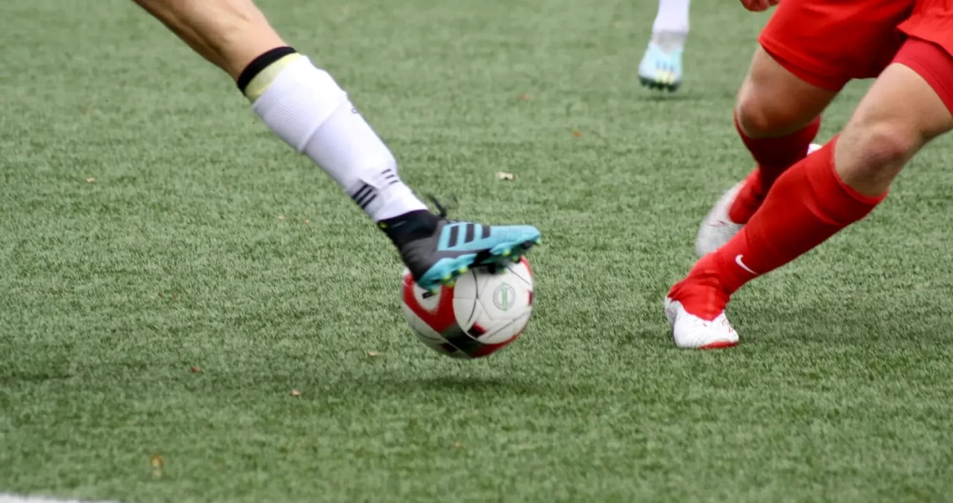 Player kicking a football on the field