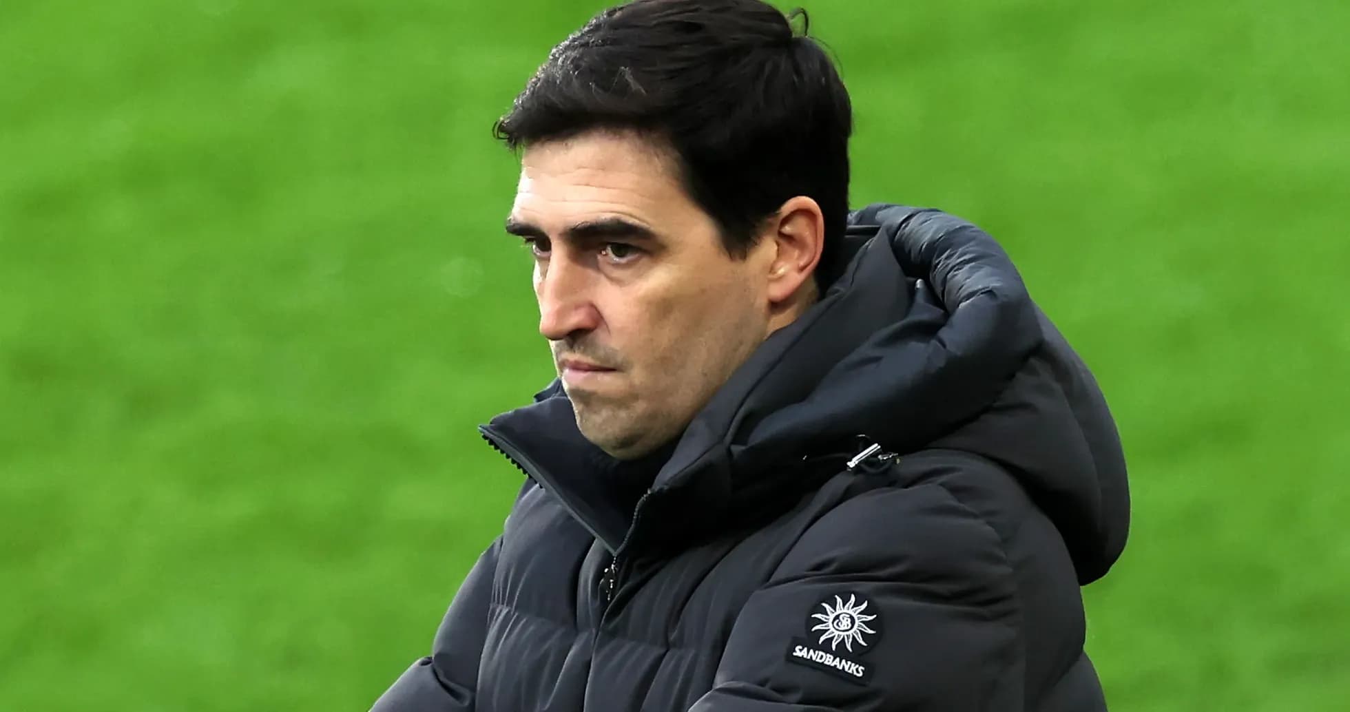 Coach observing the match with focused expression