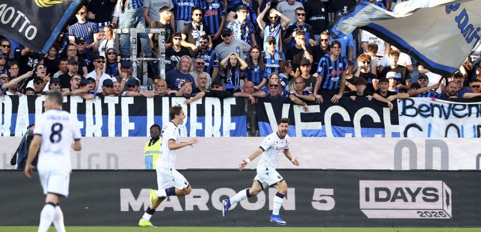 Players celebrating goal with enthusiastic fans