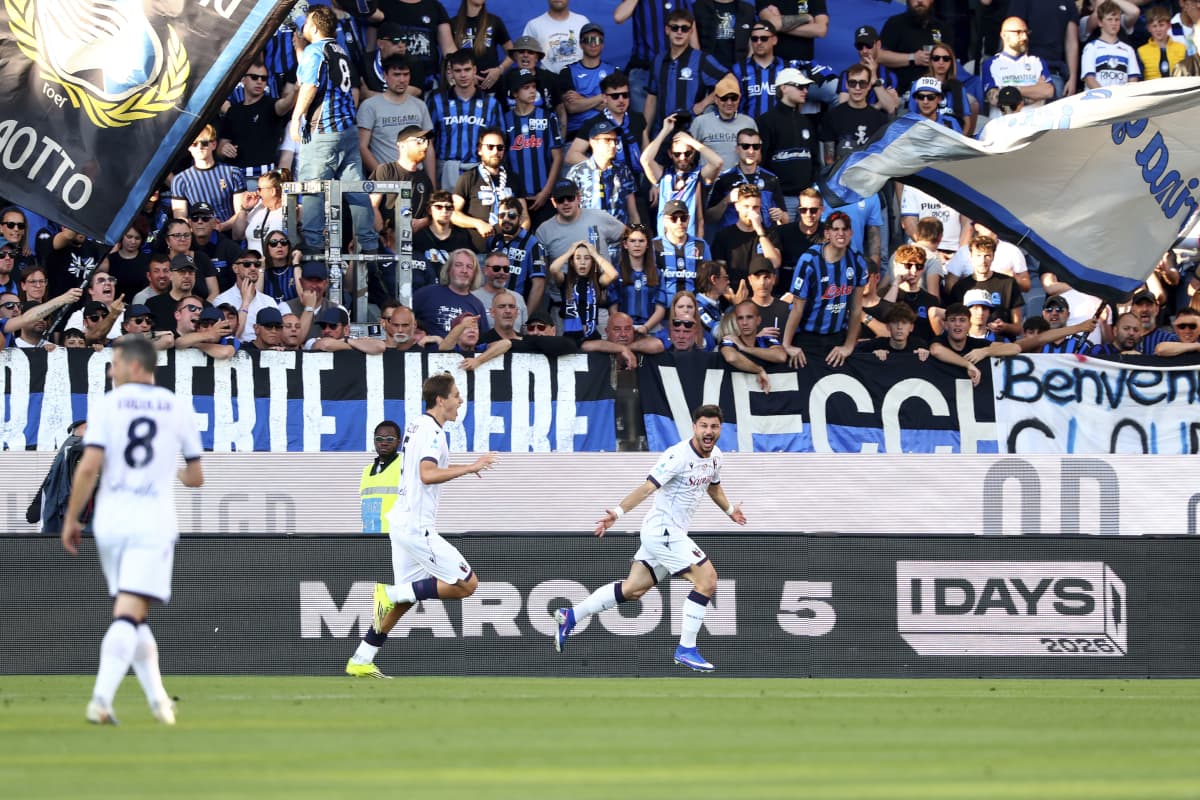 Players celebrating goal with enthusiastic fans