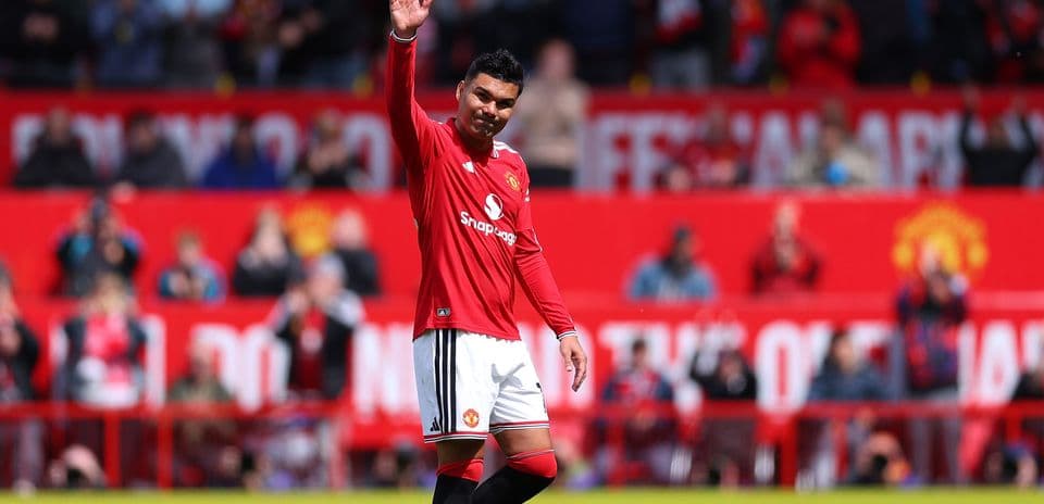 Player waving to fans during match at Old Trafford