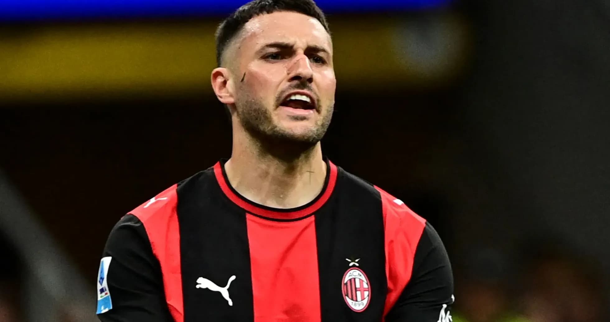Player in AC Milan jersey during match action