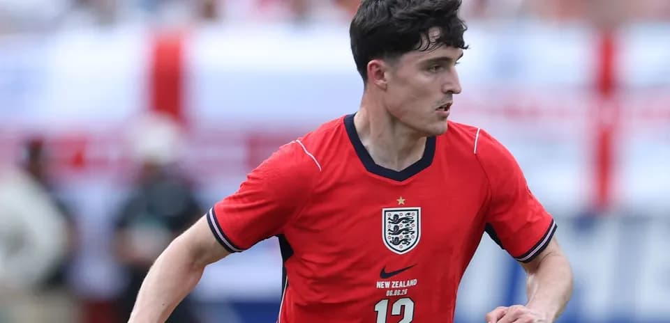 Player running with ball in red England jersey