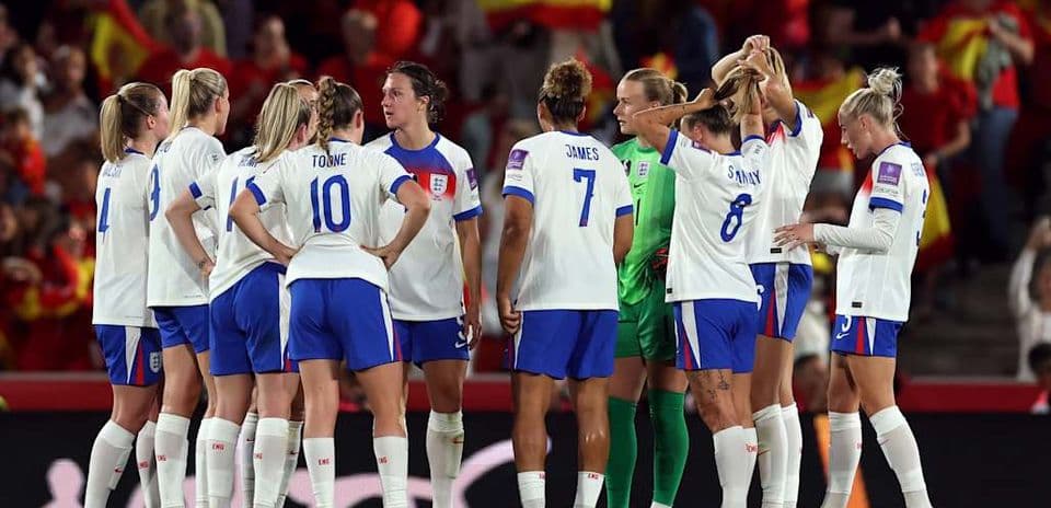 England women's team huddled during match