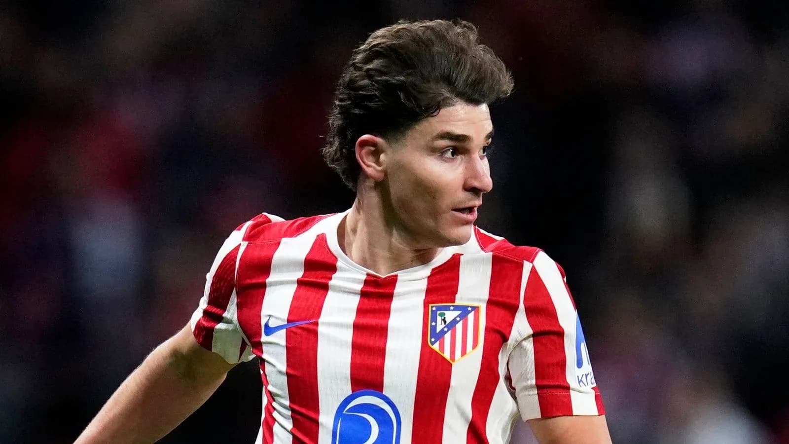 Atletico Madrid player in striped red and white jersey
