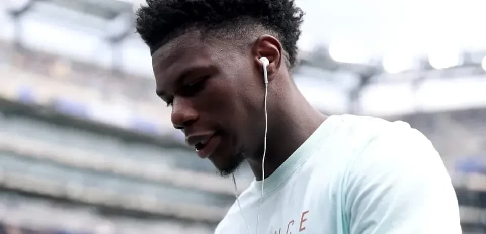Player wearing earbuds, looking down on the field