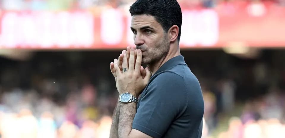 Coach observing the match with hands clasped