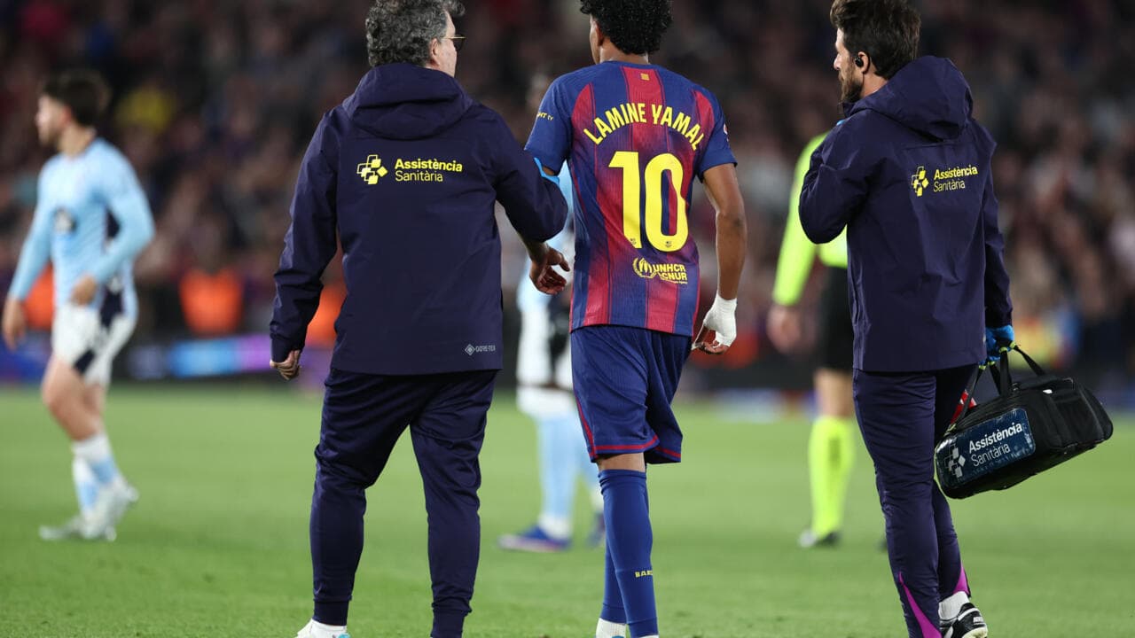 Player Lamine Yamal receiving medical assistance on field