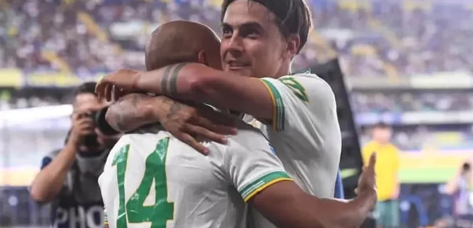 Two players celebrating with an embrace after match