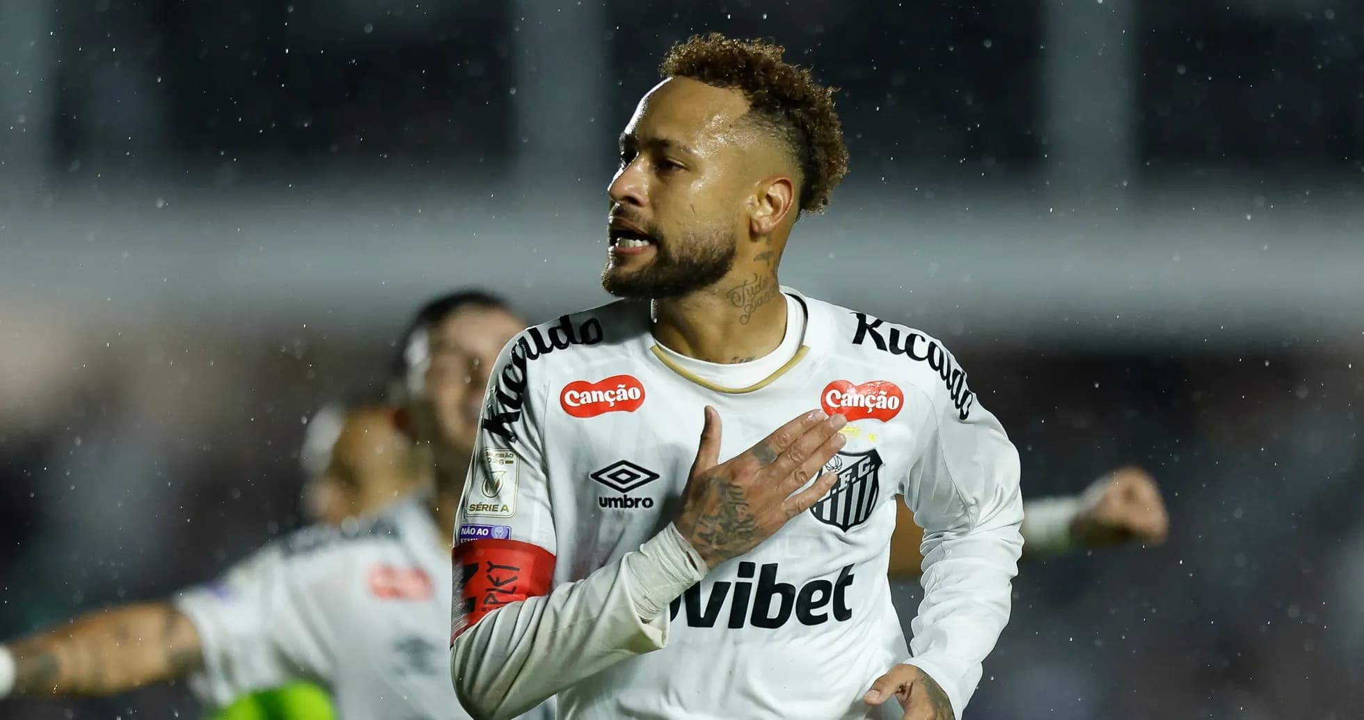 Player celebrating during match in rainy conditions