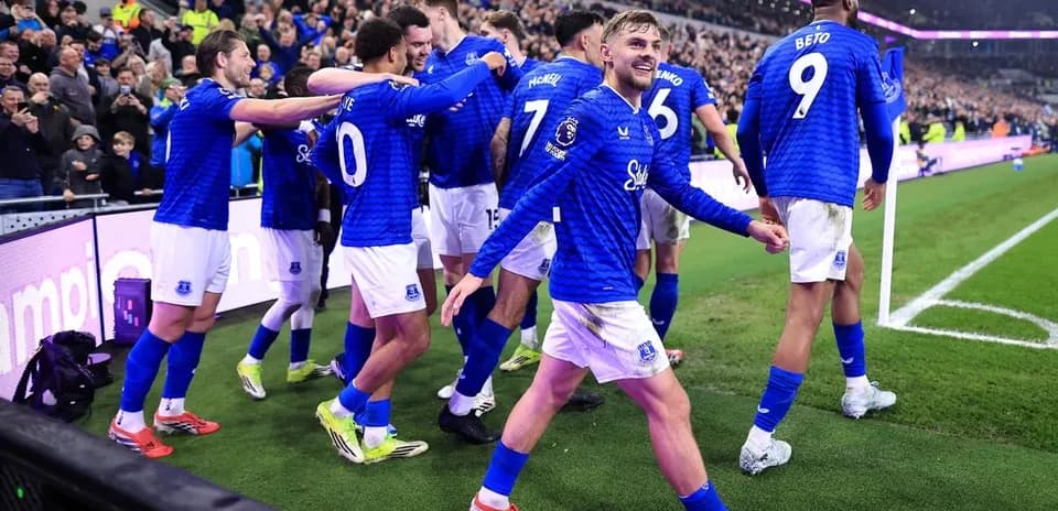 Everton players celebrating a goal with fans