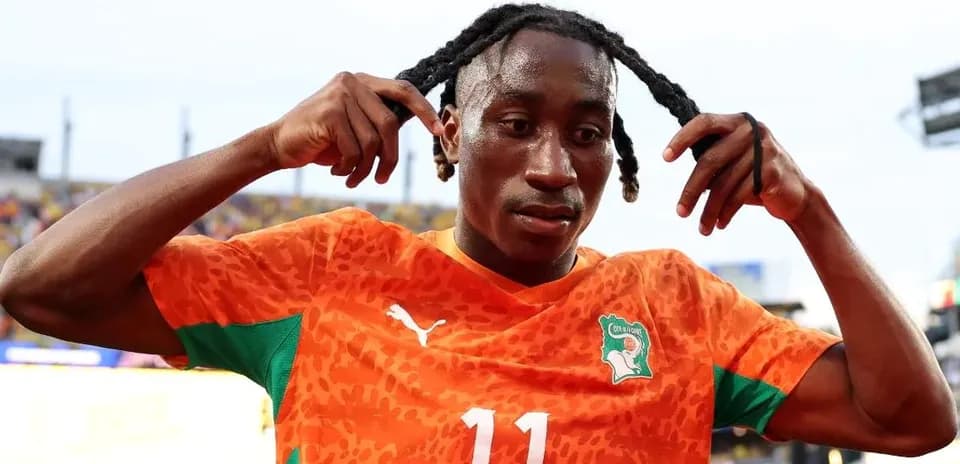 Player adjusting hair after a match in orange kit