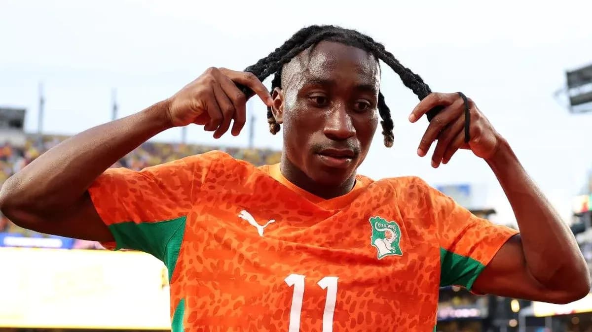 Player adjusting hair after a match in orange kit