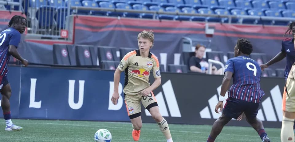 New England II player dribbling against New York RB II