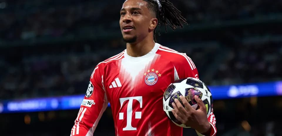 Player holding a UEFA Champions League ball on field
