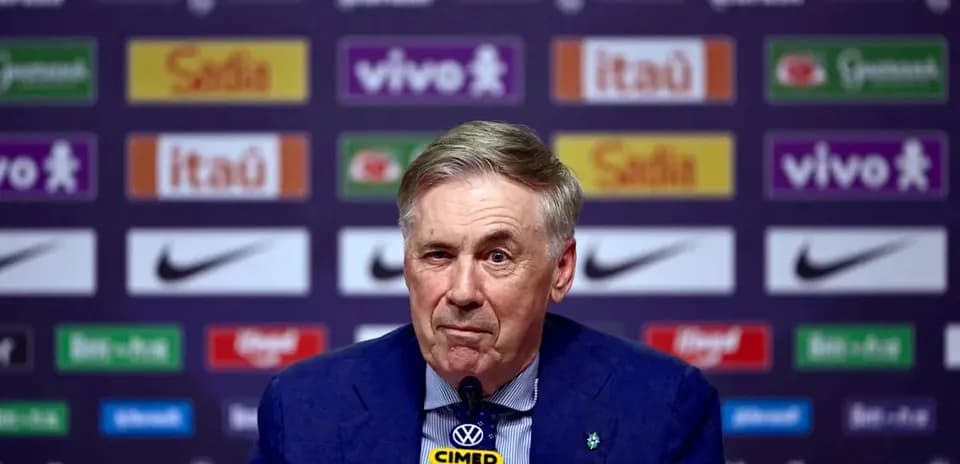 Manager speaking at press conference with logos behind