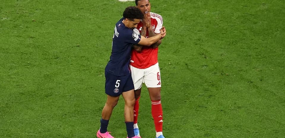 Two players embracing on the football pitch