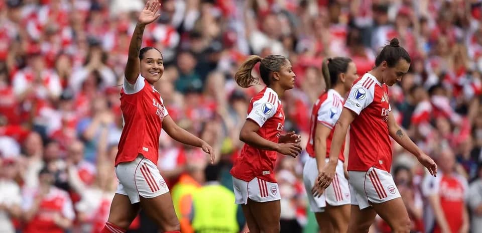 Arsenal women's players celebrating a goal together