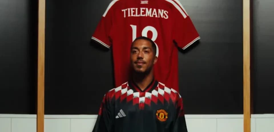 Player standing in front of jersey display