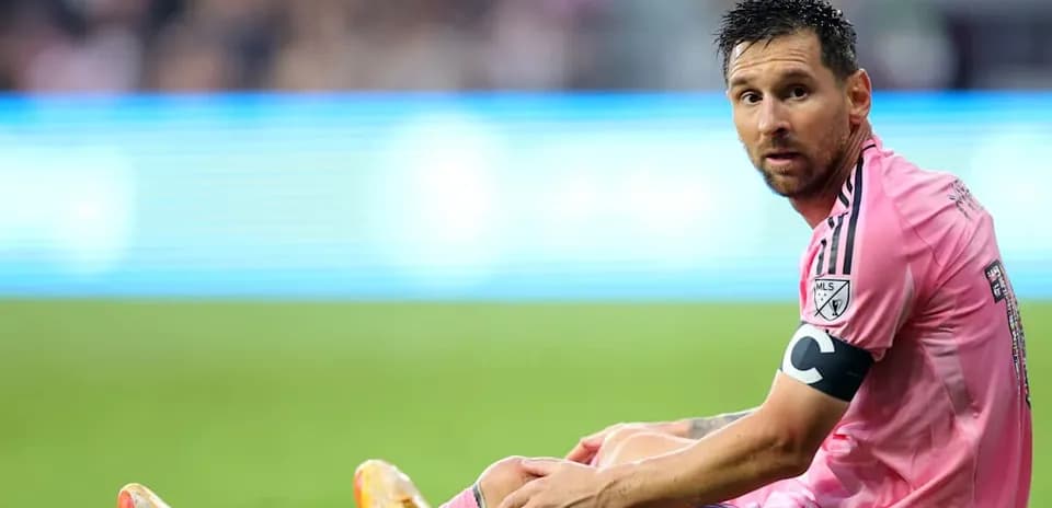Player sitting on field in pink uniform